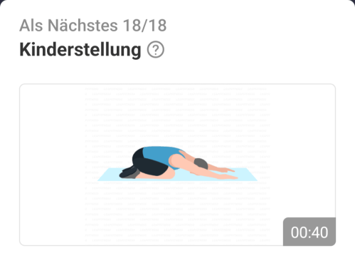 Ein Mann in Sportkleidung führt die Kinderstellung (Balasana) auf einer Matte aus.